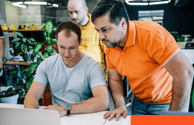 Software developers reviewing application architecture on a monitor