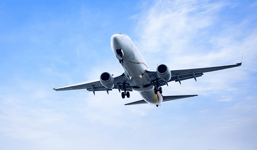 Cargo aircraft flying over a runway