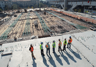 Construction workers standing on a building site seen from above