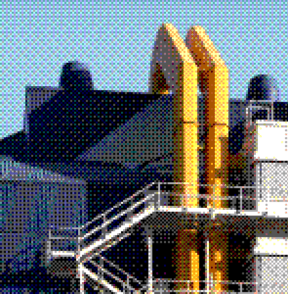 Industrial building with yellow pipes and a steel staircase