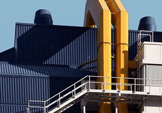 Industrial building with yellow pipes and a steel staircase