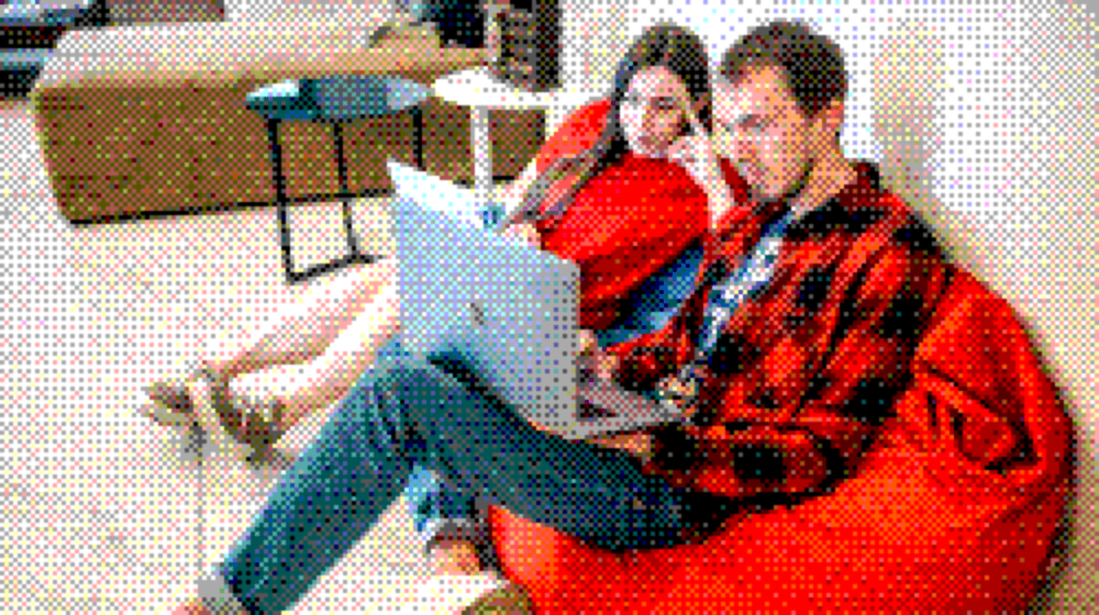 Two colleagues planning a project together on a bean bag