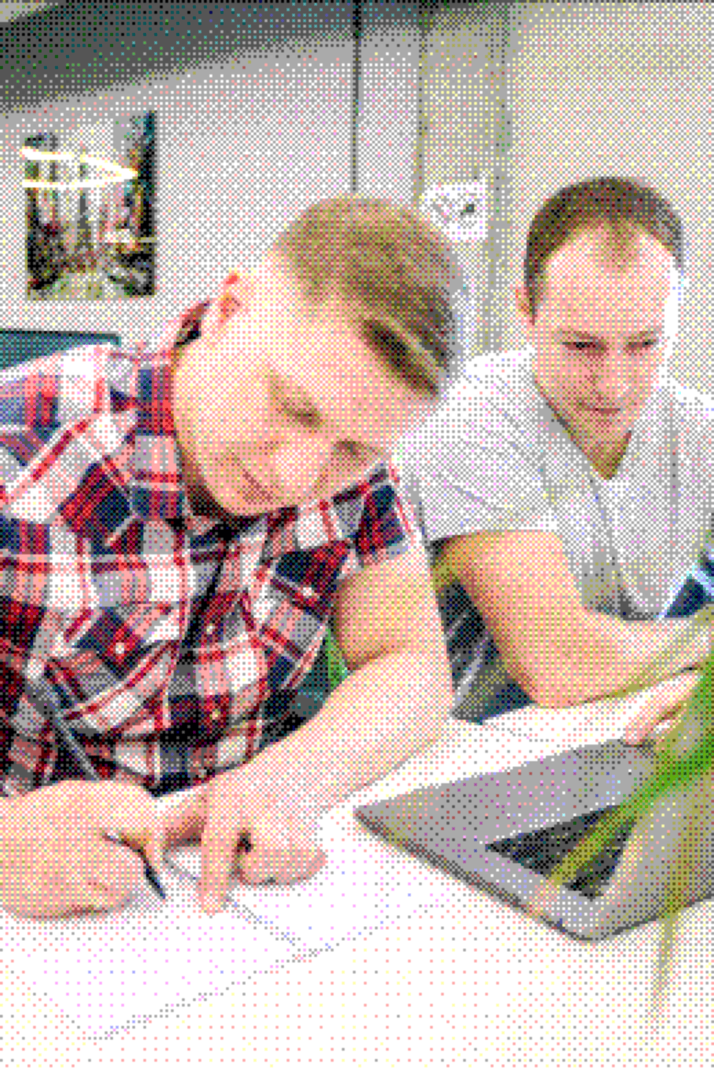 Two colleagues working together on a SaaS product plan
