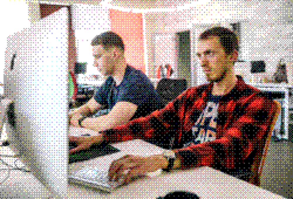 Two Integrio developers working together at a computer